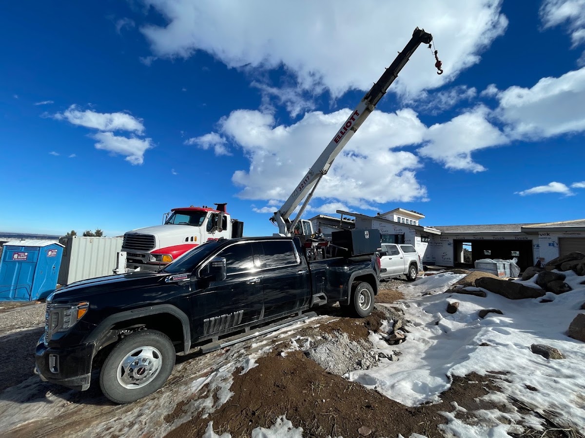 Larry's Mobile Welding service truck and crane at an outdoor jobsite